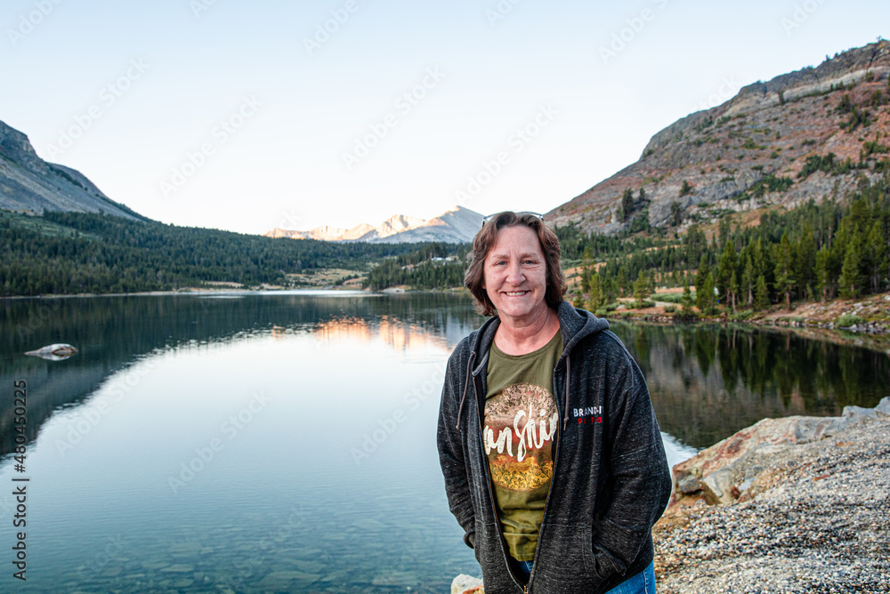 Woman in Front of Mountain Scene Reflected in Lake at Yosemite National Park