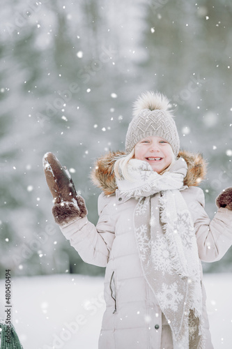 little child playing with snow