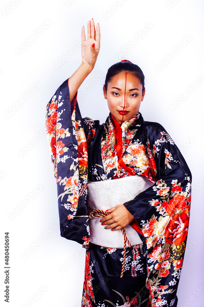 young pretty geisha in black kimono posing isolated on white background, asian ethno