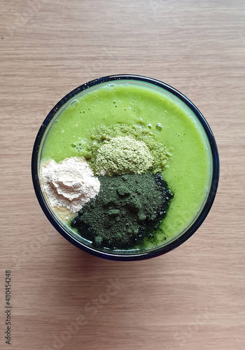 Green smoothie with freeze dried super food powder on top