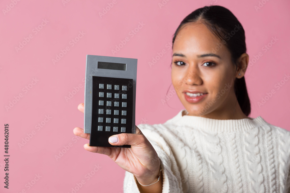 Young latina girl with calculator in hand Young latina girl with calculator in hand