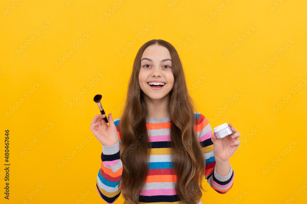I love changing my makeup. Happy child apply cosmetics. Girl smile using makeup brush. Visage