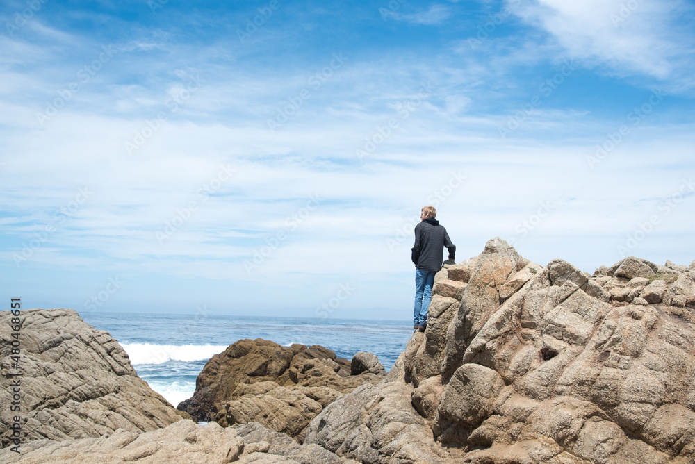 Adventurous Man Standing on Cliffs Along Pacific Coast Highway One in California