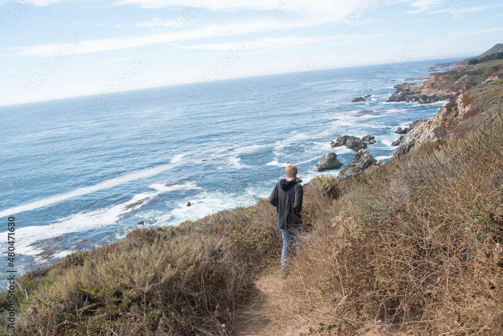 Man Hiking Down Seaside Trail Along the California Coast at Big Sur