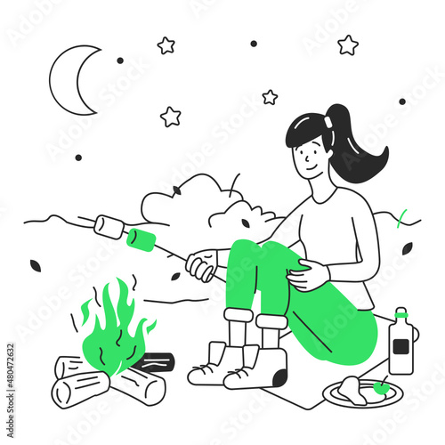 woman roasting marshmallows on a stick by the fire