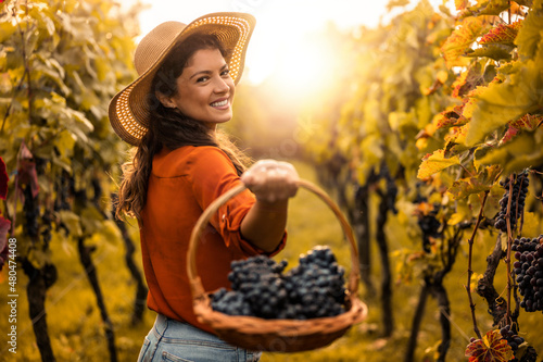 Принти на полотні Woman with basket of grapes in vineyard