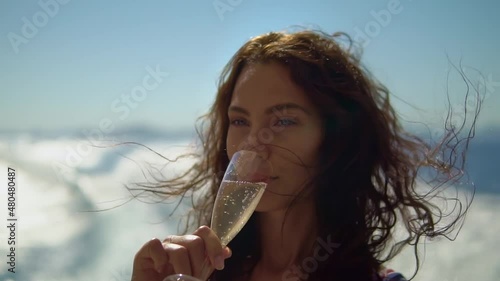Woman on the yacht drinks champagne and enjoys her vacation while sailing