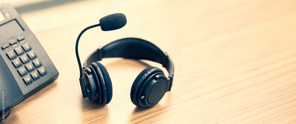 Headset and telephone for communication helpdesk IT support or call center and customer service. Headset and telephone for communication helpdesk IT support or call center and customer service.