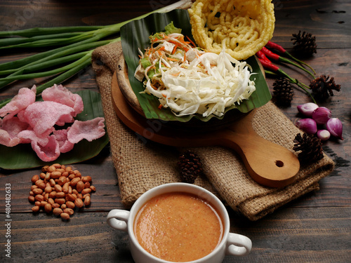 Selective focus of Asinan Betawi. The vegetable asinan of the Betawi people from Jakarta is preserved Chinese cabbage, cabbage, bean sprouts, tofu, and lettuce served with peanut sauce and krupuk. photo