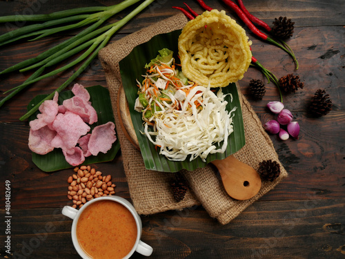 Selective focus of Asinan Betawi. The vegetable asinan of the Betawi people from Jakarta is preserved Chinese cabbage, cabbage, bean sprouts, tofu, and lettuce served with peanut sauce and krupuk. photo