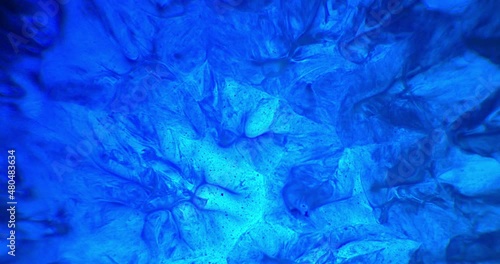Blue ink and paint liquid reaction abstract texture background 