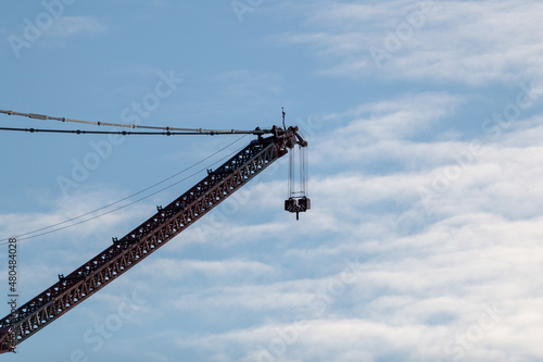 A massive ALE SK350 crane, one of the largest land-based cranes in the world, on site at the West White Rose Project at the Argentia Industrial Park against a cloudy blue sky.