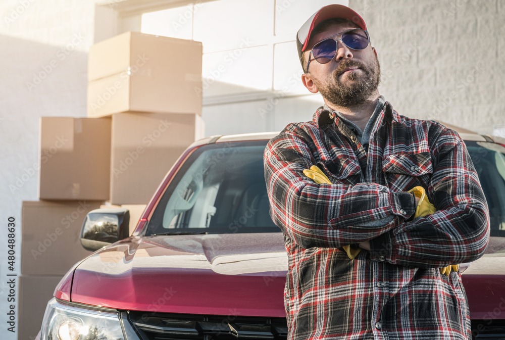Fototapeta premium Proud Contractor Worker Next to His Pickup Truck and Cargo Boxes