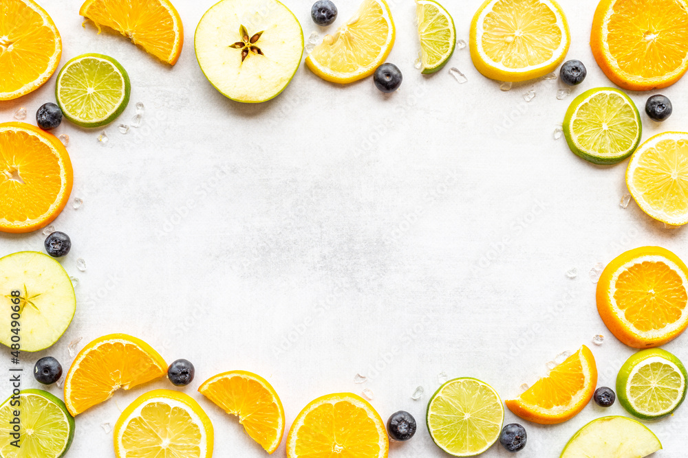 Frame of slices citrus fruits and berries for cocktail or juice, top view Frame of slices citrus fruits and berries for cocktail or juice, top view