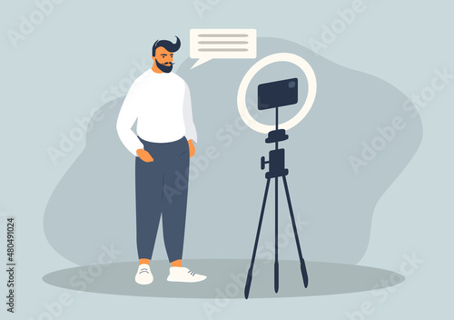 vector flat style illustration on the theme of blogging, shooting video content. man blogger shoots video on a smartphone.