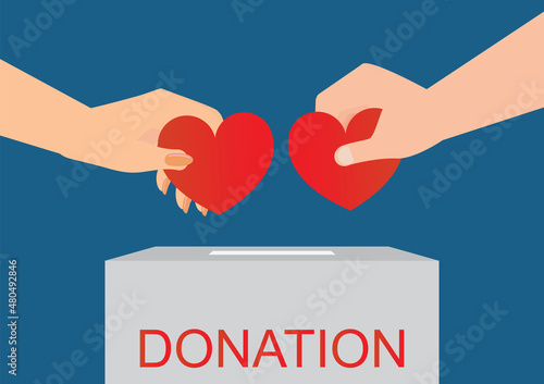 Couple throw hearts into a box for donations. photo