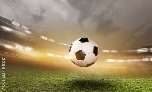 Soccer ball with football player kick off and moving under the spot ray light effects on green field, 3D illustration, of free space for texts and branding.
