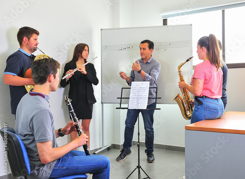 Music conservatory teacher, corrects the lesson in the classroom.