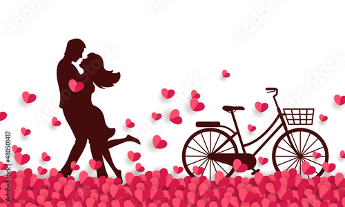 Couple hugging at a field of paper hearts and having a bicycle.