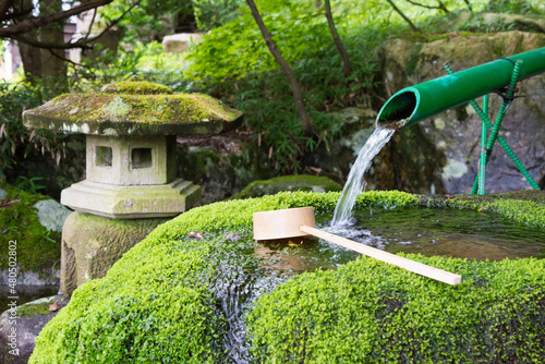Gifu, Japan - Jul 30 2017- Spring water at Hatoya Hachiman shrine in Shirakawago, Gifu, Japan. a famous historic site. photo