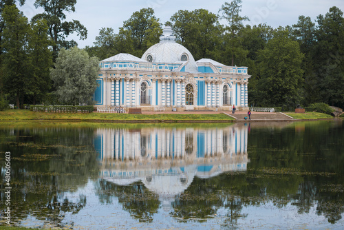 View of the ancient pavilion "Grotto" on the Big Pond on a cloudy July day. Catherine Park in Tsarskoye Selo. Surroundings of St. Petersburg. Russia