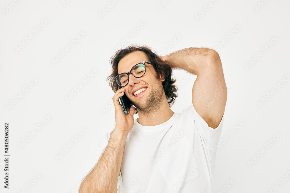 Cheerful man talking on the phone technologies isolated background Cheerful man talking on the phone technologies isolated background