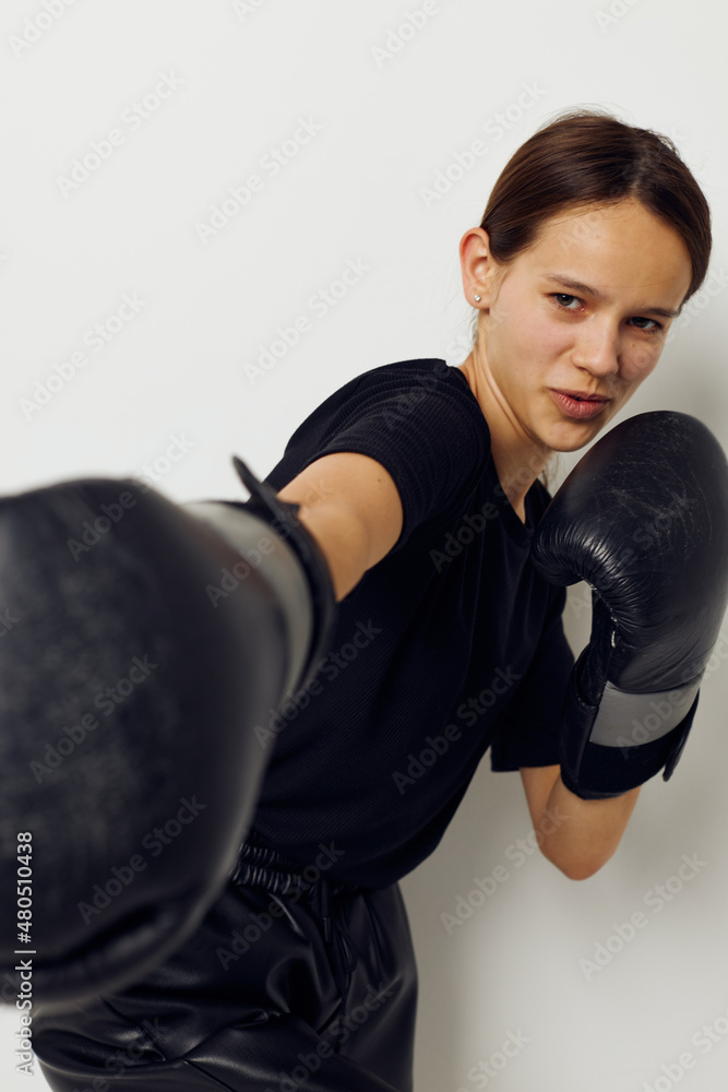 photo pretty girl in black sports uniform boxing gloves posing Lifestyle unaltered