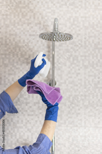 cleaning and washing the shower close-up of a girl's hand