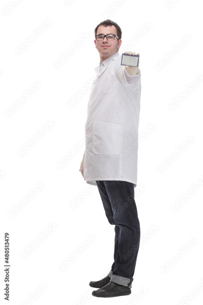 Young doctor holding business blank card and smiling at camera Young doctor holding business blank card and smiling at camera