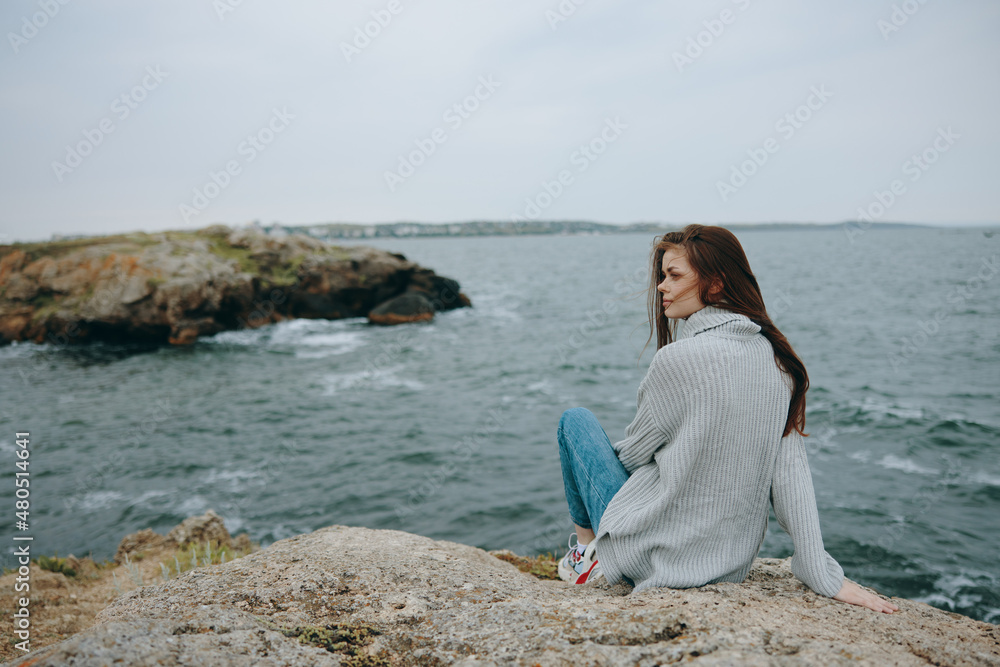 portrait of a woman long hair nature rocks coast landscape female relaxing