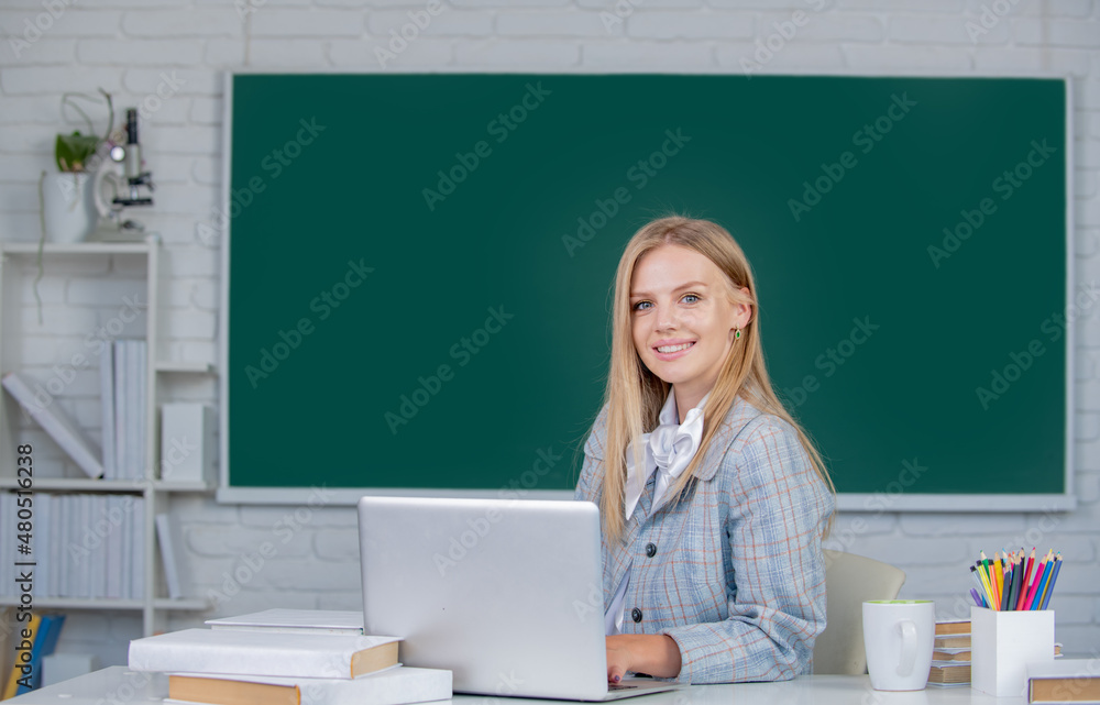Student preparing exam and learning lessons in school classroom on blackboard background. Student preparing exam and learning lessons in school classroom on blackboard background.