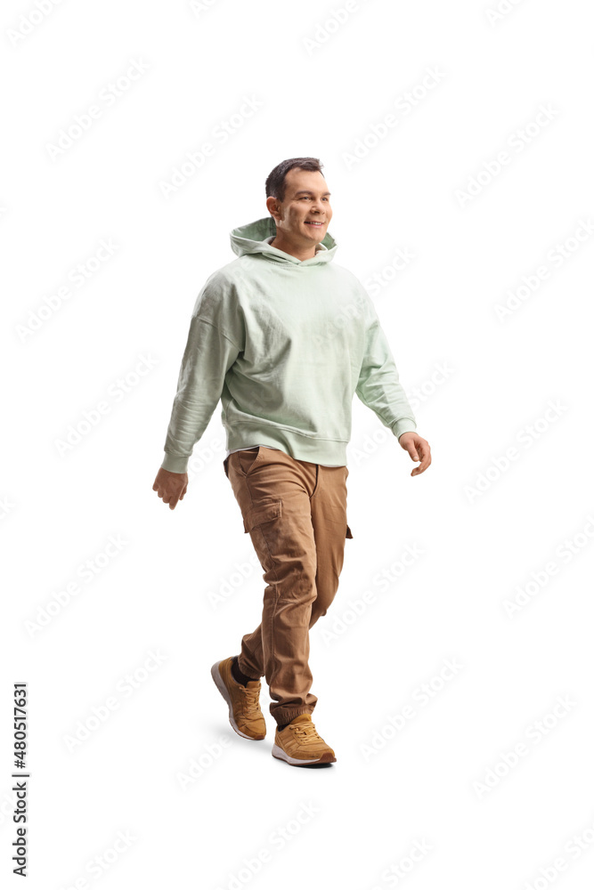 Full length shot of a smiling man in casual wear walking Full length shot of a smiling man in casual wear walking