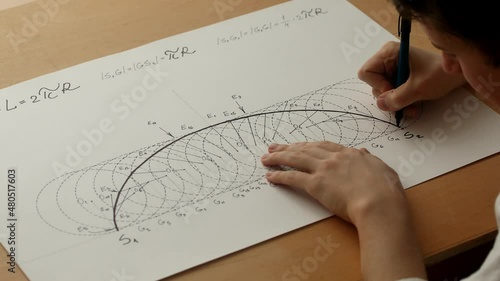Young mathematician and artist Pavel Kubarkov, drawing arc of cycloid with using a marker pen. Date of shooting day 28 December 2021 year, MSK time. This video was filmed in Russia. photo