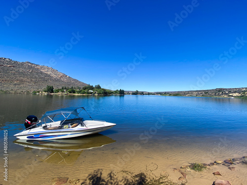 Speedboat on Bulshoek Dam on a summer's day. Fun, adventure, summer, holiday concepts. © Fables Collective