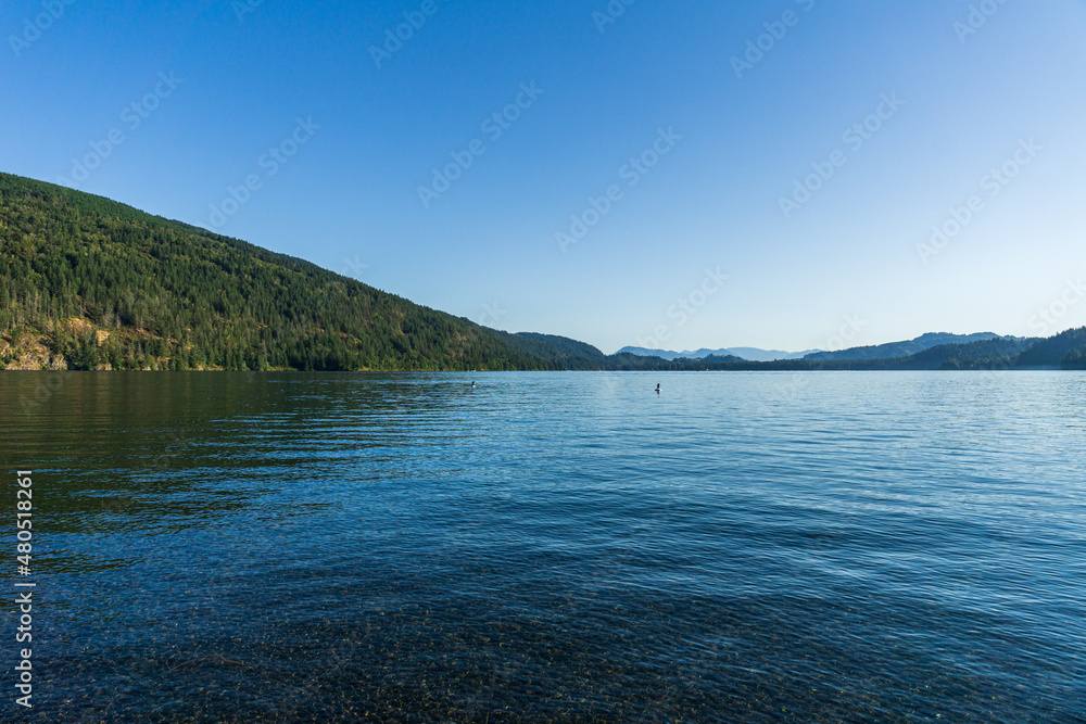 Cultus lake against the beautiful big mountain covered with coniferous forest summer landscape