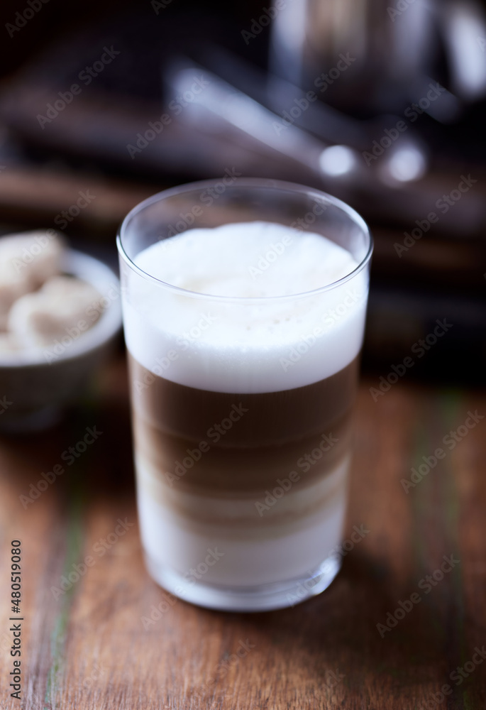 Coffee with milk on wooden background. Soft focus. Close up. Coffee with milk on wooden background. Soft focus. Close up.