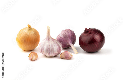 A mixture of fresh garlic, red and yellow onions on a white background.