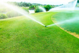 Sprinklers watering system working of green golf course.