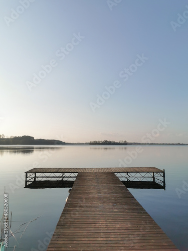 Wallpaper Mural Wooden platform on the lake. Horizon, blue water and clear sky at the dusk. Blue background and space for text.  Torontodigital.ca