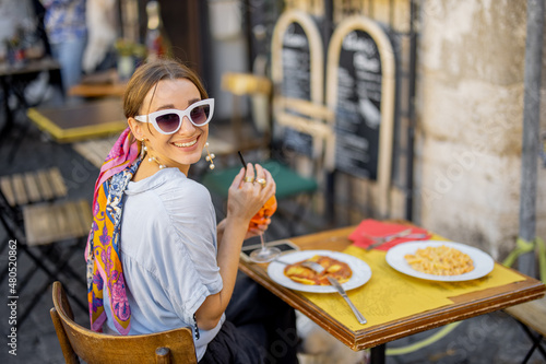 Photography Woman eating italian pasta and drinking wine at restaurant on the street in Rome