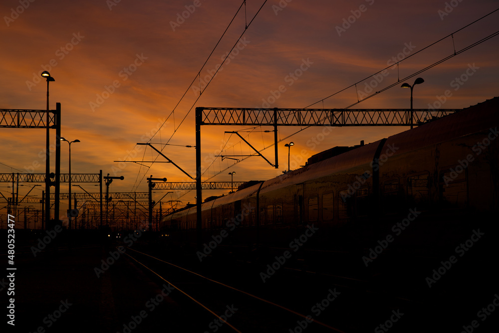 A sky full of colors after sunset with visible railway infrastructure.