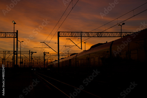 A sky full of colors after sunset with visible railway infrastructure.