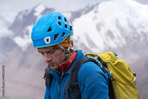 Portrait of a climbing man in a helmet.