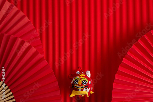 Chinese new year. Red abstract background with hand paper fan and tiger for product presentation.