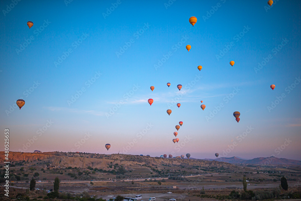 GOREME, TURKEY - SEPTEMBER 18. 2021: Bright hot air balloons in sky of Cappadocia, Turkey
