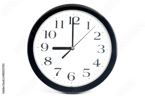 Black classic clock on isolated white background.