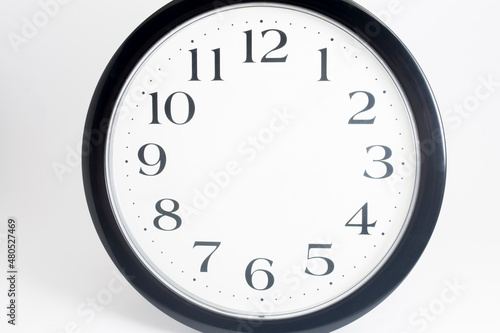 Empty black clock without dial on isolated white background with shadow. 