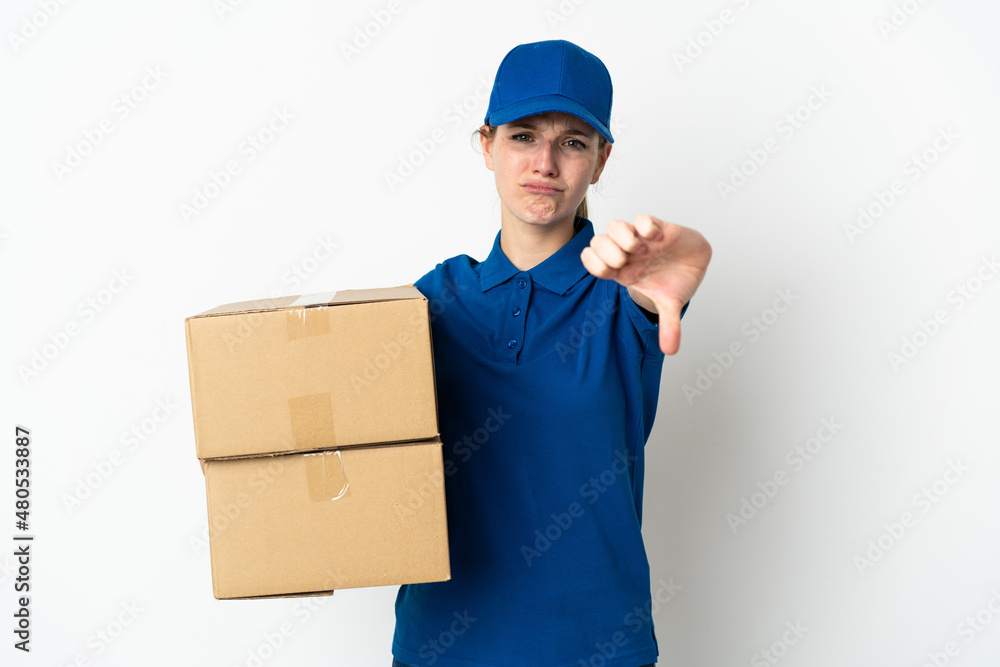 Young delivery woman isolated on white background showing thumb down with negative expression Young delivery woman isolated on white background showing thumb down with negative expression