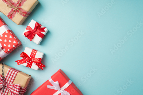 Top view photo of st valentine s day decorations stylish gift boxes with bows on isolated pastel blue background with copyspace