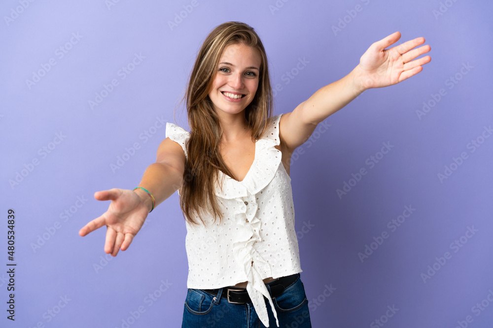 Young caucasian woman over isolated background presenting and inviting to come with hand Young caucasian woman over isolated background presenting and inviting to come with hand